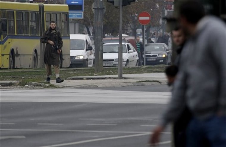 An unidentified gunman stands in the center of the street in Sarajevo, Bosnia, on Friday at a street in front of the U.S. embassy. For at least 30 minutes the man stood at a street in front of the U.S. embassy in Sarajevo and shot around from an automatic rifle. 
